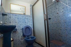 a bathroom with a blue toilet and a sink at Hostal Terra Sal - Bed, Breakfast, Garage & Salar de Uyuni Tours in Uyuni +103 photos