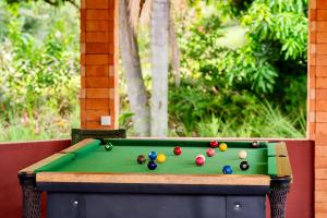 a pool table with balls on top of it at Hotel Fazenda Vale Alvorada in Toledo