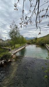 a river with a bridge in the middle of it at Casa Oliva in Orahovo
