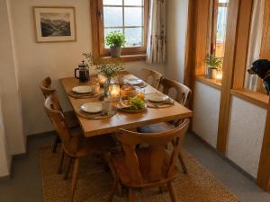 a wooden table with food on it in a dining room at Ferienwohnungen Pez Regina in Lumbrein
