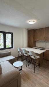 a living room with a couch and a table and chairs at Casa Oliva in Orahovo