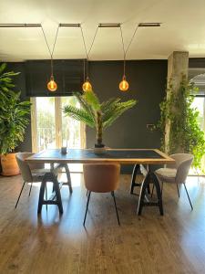 a dining room with a table with a plant on it at LOFT "EL PARQUE" in Níjar