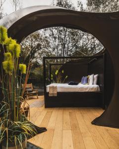 a bedroom with a bed under a black canopy at Elements Lodges in Pettigoe