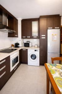 a kitchen with a white refrigerator and a washer at Xorroxin in Elizondo