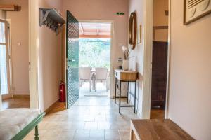 a hallway with a room with a sink and a mirror at The Homey in Sidari
