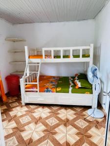 two bunk beds in a room with a floor at Roi immo 2 in Mahajanga