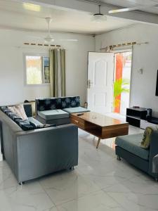 a living room with couches and a coffee table at Roi immo 2 in Mahajanga