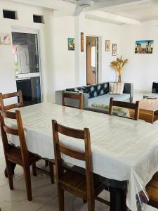 a living room with a table and chairs and a couch at Roi immo 2 in Mahajanga