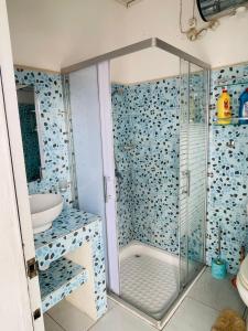 a bathroom with a shower and a sink at Roi immo 2 in Mahajanga +3 photos