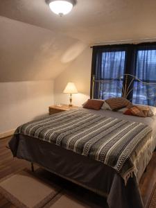 a bedroom with a large bed with a window at Aurora House in Ironwood