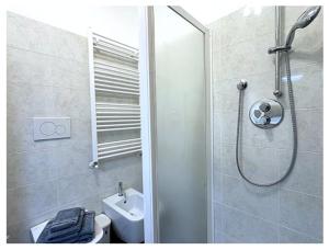 a bathroom with a shower and a toilet and a sink at SunLake Apartment in Colico +12 photos