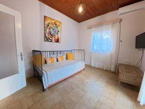 a bedroom with a bed and a painting on the wall at The Homey in Sidari