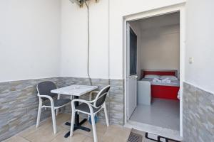 a small table and chairs in a room with a bed at Villa Deart Berat in Berat