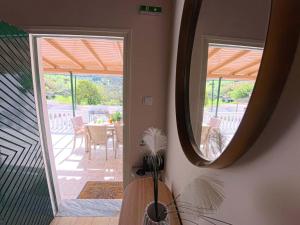 a mirror in a room with a table and a patio at The Homey in Sidari