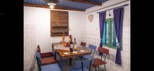 a dining room with a table and chairs with wine bottles on it at Jelkő Ház in Terpes