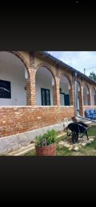 a brick building with a wheelbarrow in front of it at Jelkő Ház in Terpes