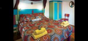 a bedroom with a bed with yellow towels on it at Jelkő Ház in Terpes +4 photos