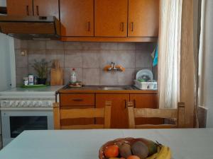 a kitchen with a bowl of fruit on a table at ambelos view in Kotronas +19 photos