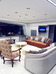 a living room with couches and tables and a tv at Hay Rezidans in Istanbul