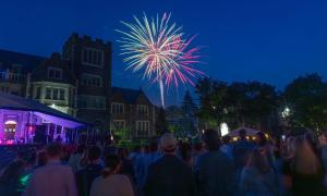 a crowd of people watching a fireworks show at night at Uptown Geneva Rowhouse Flat in Geneva