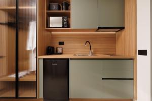 a small kitchen with a sink and a refrigerator at Little Crab Suites in Agios Gordios