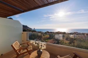 a balcony with a view of the ocean at Little Crab Suites in Agios Gordios