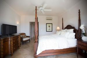 a bedroom with a bed with a television and a dresser at Sweet Dreams in Saint James