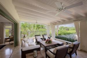 a living room with a ceiling fan and a table at Sweet Dreams in Saint James