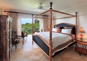 a bedroom with a canopy bed and a balcony at Sweet Dreams in Saint James +17 photos