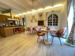 a kitchen and dining room with a table and chairs at Historic family house in Montefiascone