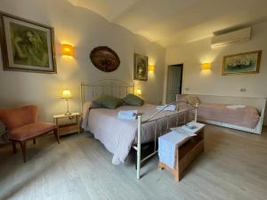 a bedroom with a bed and a chair at Historic family house in Montefiascone