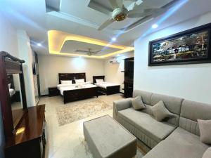 a living room with a couch and a bed at The Canvas Hotel in Abbottabad