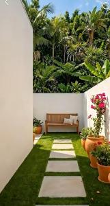 a garden with a bench and some plants at Serendib Villa in Negombo