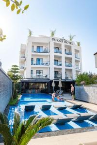a hotel with a pool in front of a building at Duka's Boutique Hotel in Ksamil