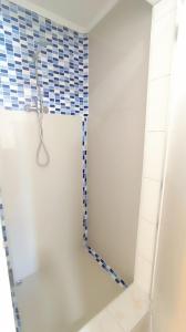 a bathroom with a shower with a mirror at Hostal Verona in Antofagasta