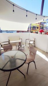 a room with chairs and a glass table and chairs at Hostal Verona in Antofagasta