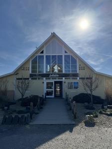 a large building with a large window on top of it at Pet-Friendly Waterside Lodge - Cotswold Water Park in Cirencester