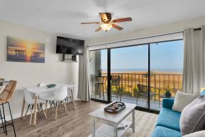 a living room with a couch and a ceiling fan at Seawind Sanctuary in Carolina Beach