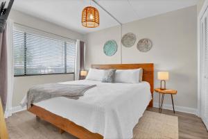 a bedroom with a large bed and a window at Seawind Sanctuary in Carolina Beach +36 photos