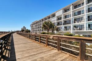 a boardwalk leading to a building on the beach at Seawind Sanctuary in Carolina Beach