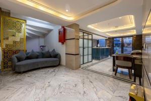 a living room with a couch and a table at Hotel Anu Plaza - Newly Built Hotel With Parking Just 6 Mins from Connaught Place ,New Delhi Railway Station & Metro Station in New Delhi +98 photos