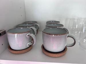 a row of coffee cups sitting on a counter at Bio Home La Asomada in Tías