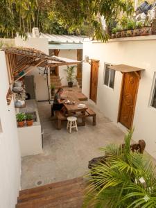 a woman sitting at a table in a courtyard at Akoma San Pancho in San Francisco