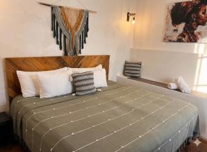 a bedroom with a large bed with white pillows at Akoma San Pancho in San Francisco