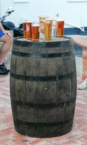 a group of glasses of beer sitting on a barrel at The Blue Bell at Cocking in Midhurst