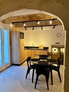 a kitchen and dining room with a table and chairs at VillageStay in Rabat +8 photos