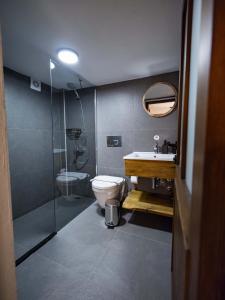 a bathroom with a toilet and a sink and a shower at Casa Alegre Alaçatı in Alaçatı +111 photos