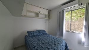 a bedroom with a bed and a window at Ilhéus Temporada in Ilhéus +16 photos