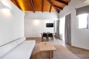 a living room with a couch and a table at Creta Elena in Chania