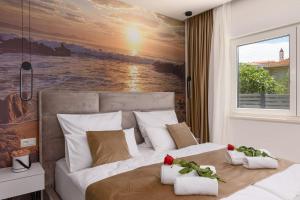 a bedroom with a large bed with a painting on the wall at Rusulica Trogir in Seget Vranjica +38 photos